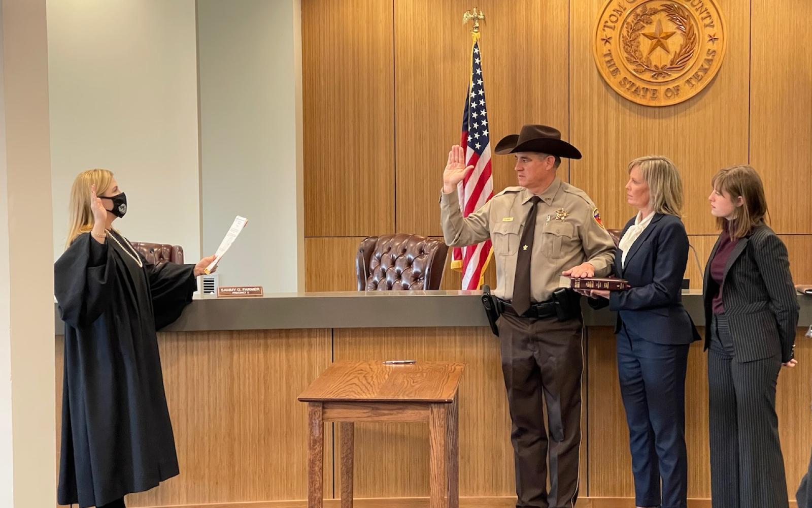 51st District Judge Carmen Dusek swears-in Sheriff Nick Hanna on the day after the overnight shooting.