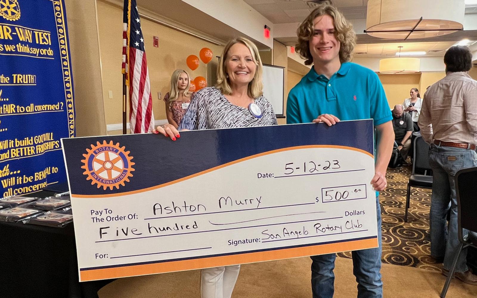 San Angelo Rotary Club President Rochel Ditmore awards a $500 scholarship check to San Angelo Central graduate Ashton Murry.