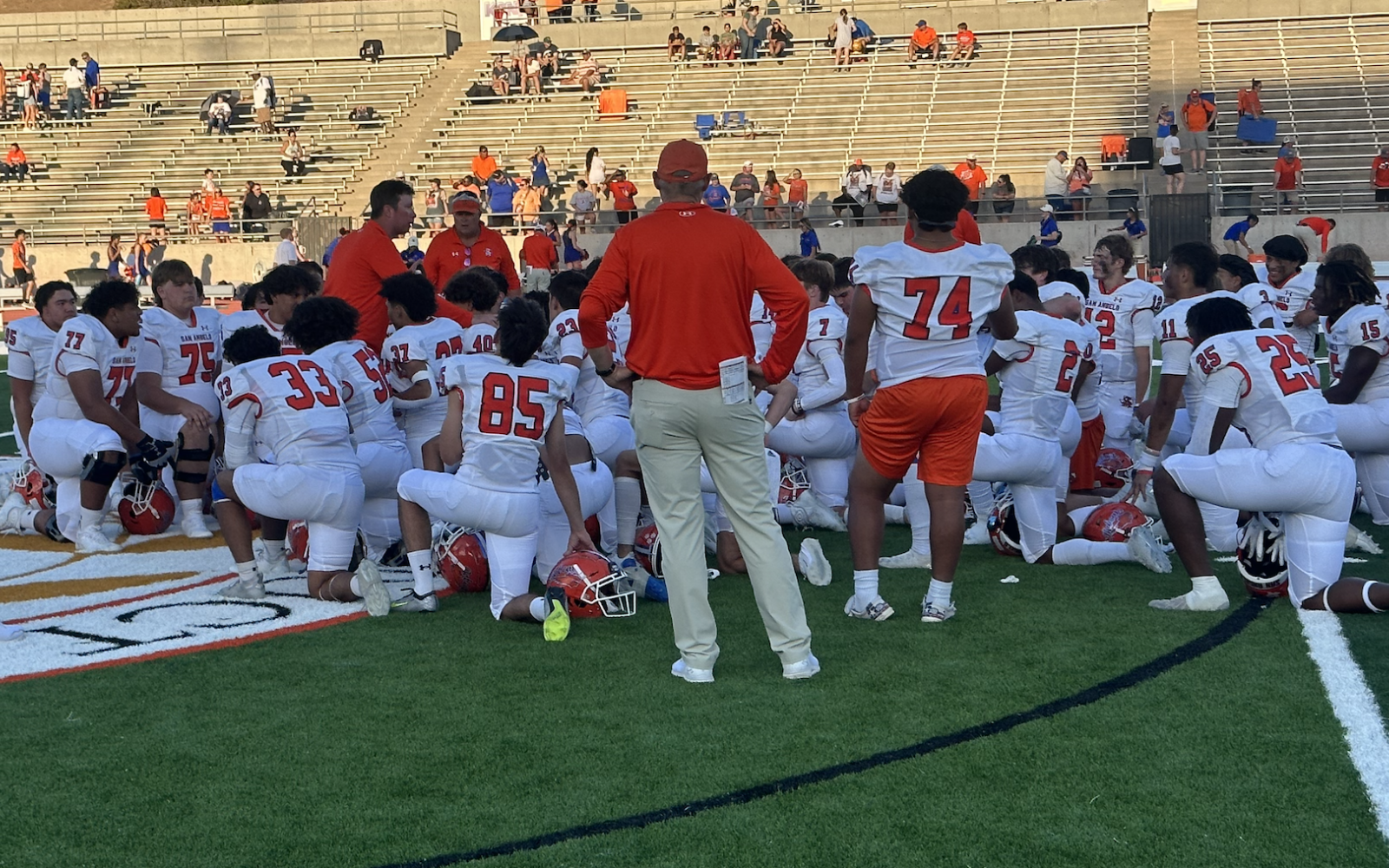 Coach Kevin Crane addresses his team after the Bobcats' victory.