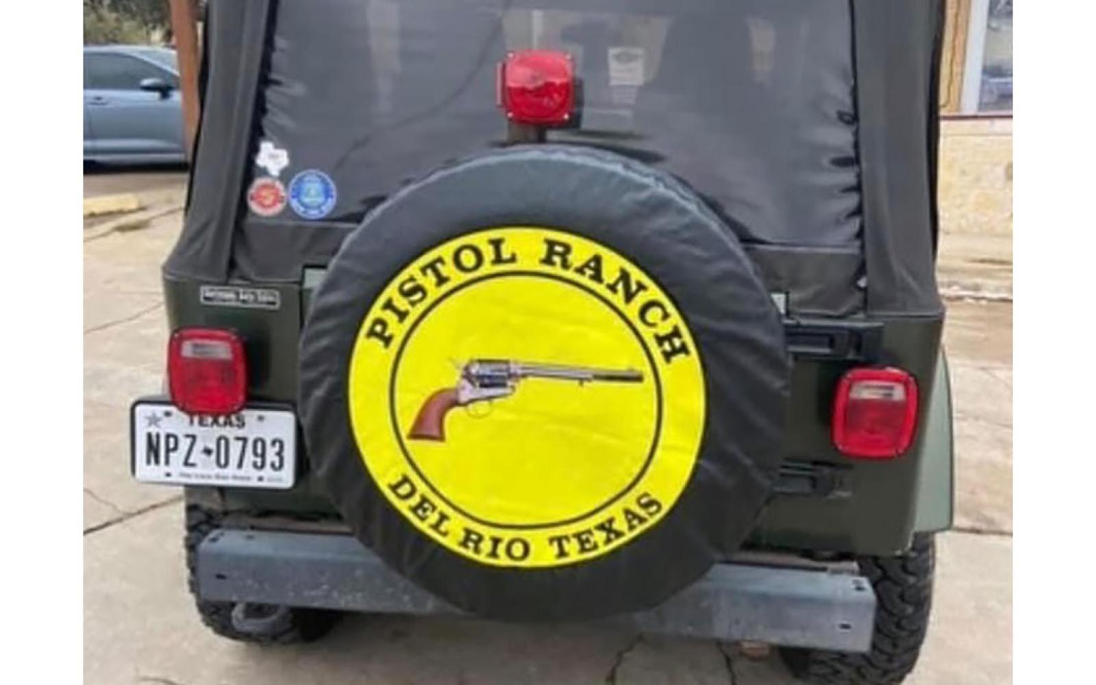 The back of Mr. Isaack's 2006 Jeep Wrangler with the distinctive wheel cover advertising his Pistol Ranch.