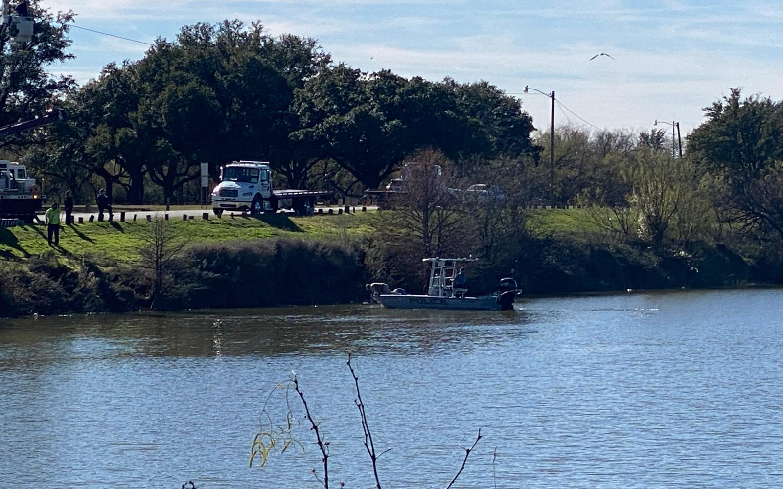 Police fish a car out of the Concho River