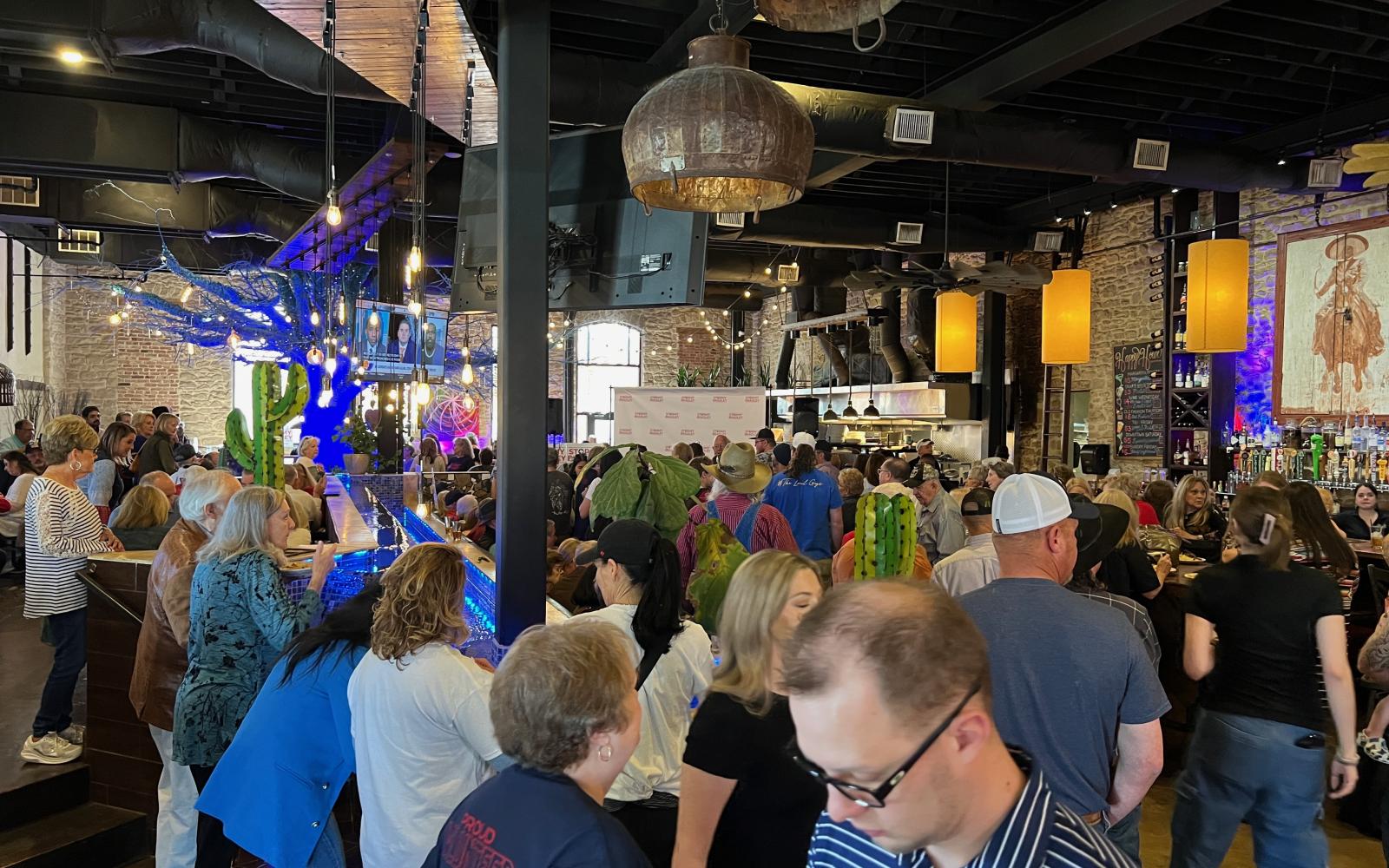 A crowd of around 150 people were gathered inside the Angry Cactus to hear Gov. Greg Abbott speak.
