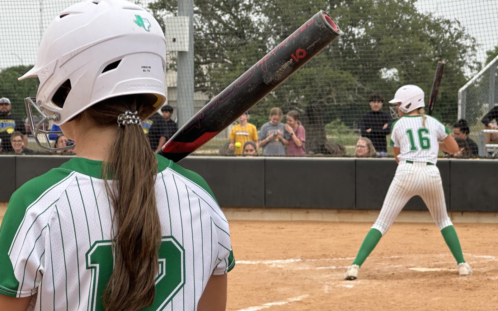 Wall Lady Hawks Abby Werner looks on from the on-deck circle while Emery Harper is at bat.