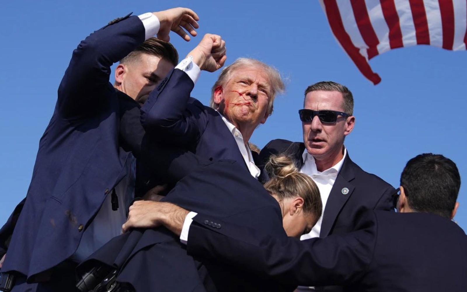 Donald Trump fist bumps as he is escorted off the grandstand during a rally where shots rang out in Butler, PA on July 13, 2024 at 5:13 p.m. CDT.