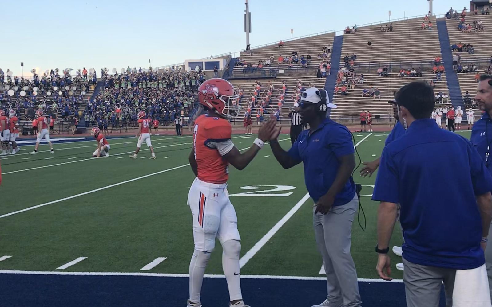 Central quarterback Christian English celebrates with an assistant coach after scoring a touchdown against Belton on Friday, Sept. 20, 2024, at San Angelo Stadium.