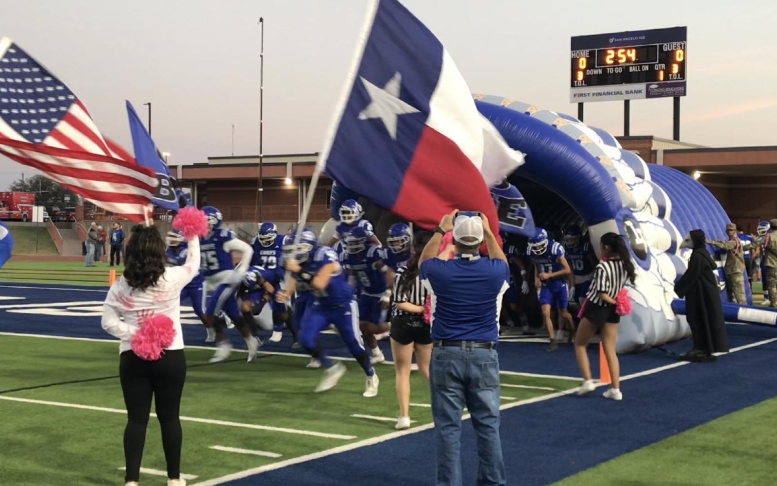 The Lake View Chiefs football team charges out of the tunnel before its game against Big Spring on Thursday, Oct. 31, 2024, at San Angelo Stadium.