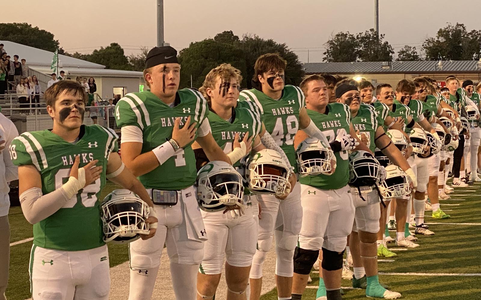 The Wall Hawks stand for the national anthem before their first-round playoff game against Anthony on Friday, Nov. 15, 2024.