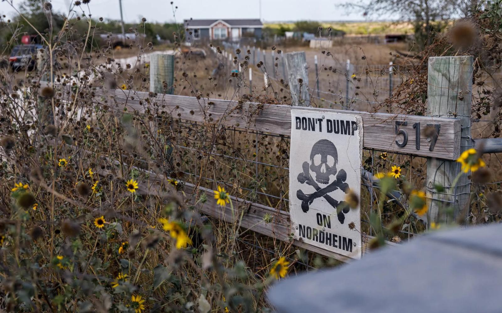 A home across the street from an entrance to an oilfield waste disposal facility has a sign reading "DON'T DUMP ON NORDHEIM" on Sept. 10, 2023. Credit: Julius Shieh/The Texas Tribune