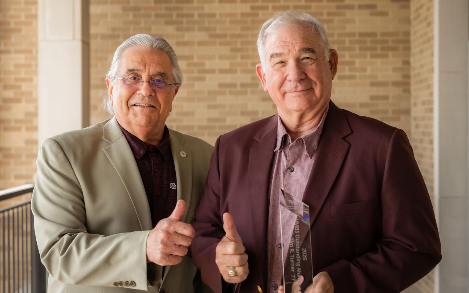 Texas A&M Dean of the College of Veterinary Medicine & Biomedical Sciences (VMBS) Dr. John August (L) with Dr. Tim R. Turner.  