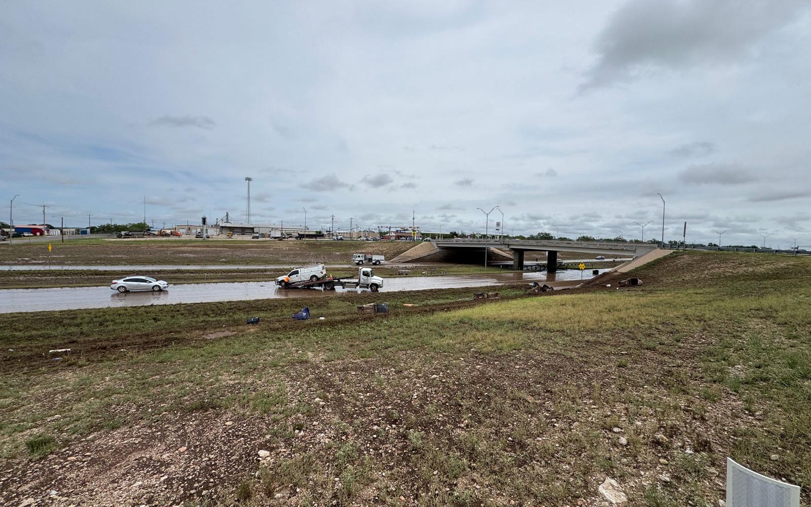 A wide view of Home Motors picking up the flooded out cars and trucks that dared to go through the high water underneath the Bell St. overpass on the Houston Harte Expy. on July 4, 2025.