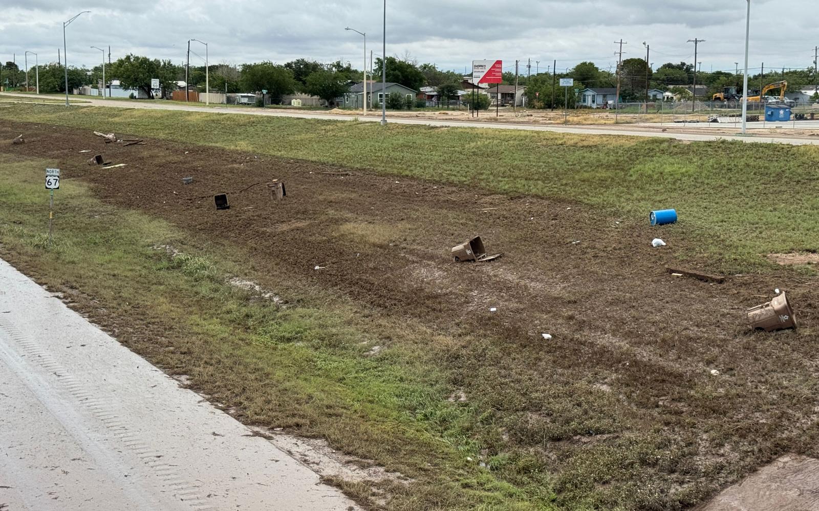 A view of the southeast embankment of the Houston Harte Expy. where residential trash carts line the water line, displaying how high the water rose on July 4, 2025. 