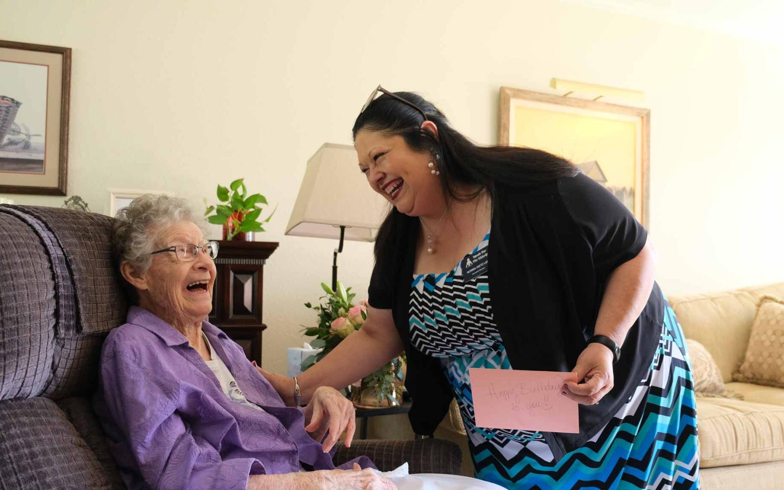 Ida Walter, seated, shares a laugh with Norma Dietz Lee, executive director of Meals for the Elderly, during Walter’s 101st birthday celebration Friday in San Angelo.