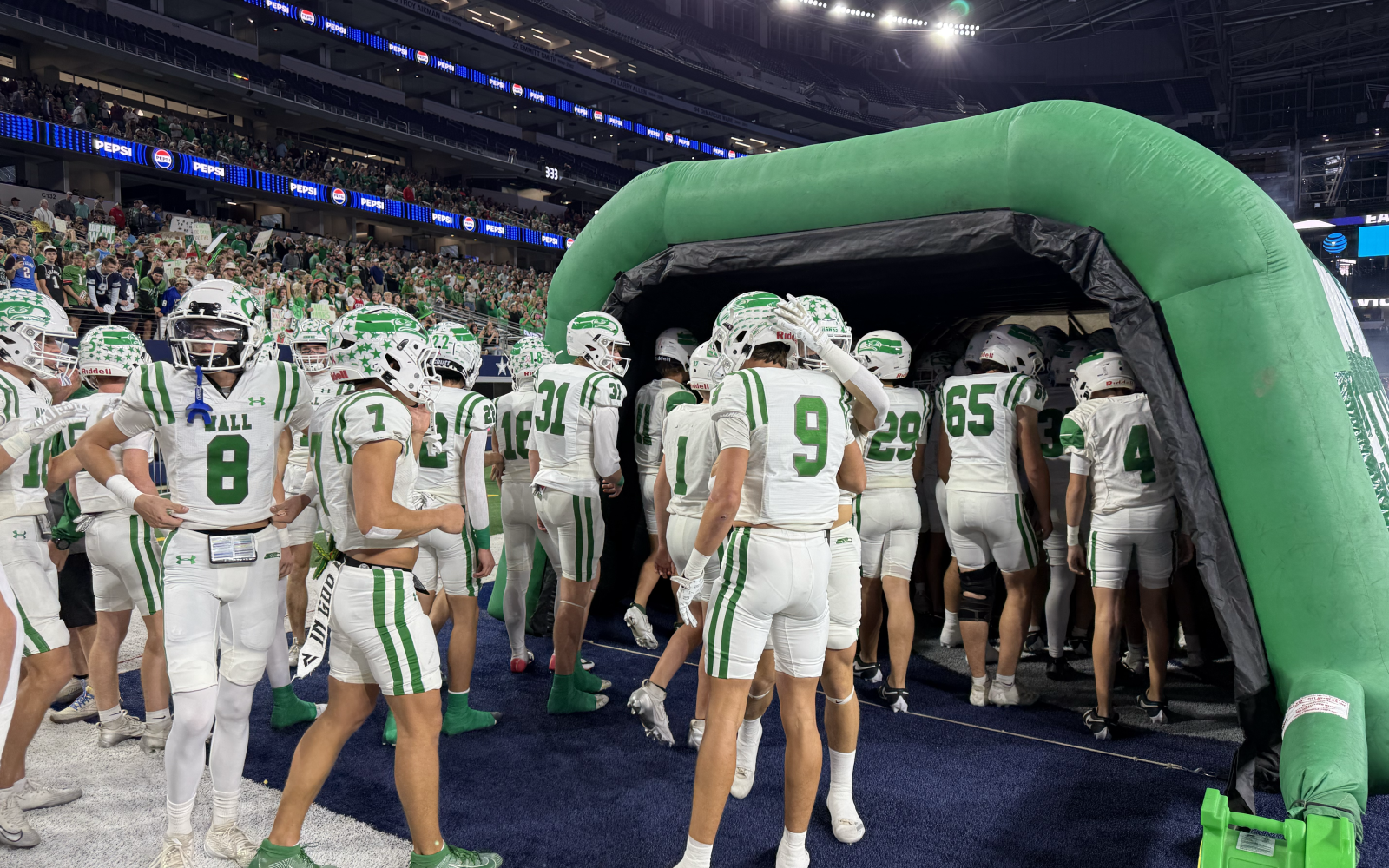 The Wall Hawks prepare to run onto the field before the Class 3A Division II state final against Newton on Thursday, Dec. 18, 2025.