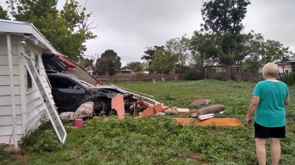 Jennifer Byrd surveys the damage cause by the black 2016 Dodge Charger that crashed all the way through their house and into the backyard on July 11, 2021. Jennifer Byrd surveys the damage cause by the black 2016 Dodge Charger that crashed all the way through their house and into the backyard on July 11, 2021.