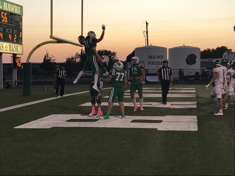 Wall's Ethan Michalewicz is picked up by Ben Taylor after a touchdown against Idalou on Friday, Oct. 4, 2024.