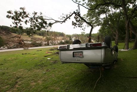 An overturned vehicle on the banks of the Blanco River on May 26, 2015, two days after catastrophic flooding in the Wimberley area.