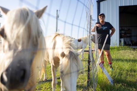 Romana Harding greets goats and miniature horses on her farm outside of Midway, on Tuesday, July 29, 2025. Romana plans to use the 10 acres she owns to make a farm for other veterans to visit and experience healing.