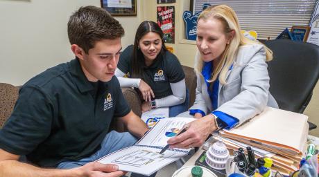 ASU business professor, Dr. Gayle Randall, working with students in her office