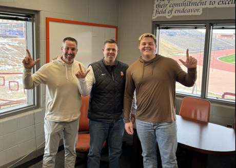 San Angelo Central junior offensive lineman Ethan Boyd is shown with Central head coach Mark Smith (left) and Oklahoma State offensive line coach Cody Crill after receiving an offer to play for Oklahoma State.