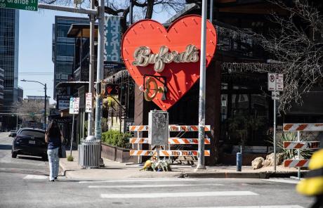 Flowers are left in front of Buford's on West 6th Street in downtown Austin on March 2, 2026. A third victim of a Sunday shooting died Monday, raising the toll to four, including the suspected gunman.