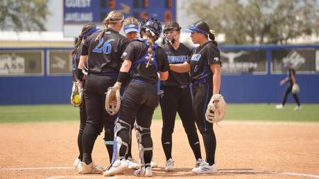 The Angelo State softball team meets at the pitcher's circle during the 2026 season.