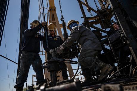 A service rig crew pulls sucker rods from an oil and gas well as they work to bring a downhole pumping unit to the surface on Aug. 14, 2024, in West Odessa.