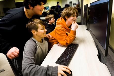 Arthur Grenner, 13, left, Chad Darden, 12, and Steve Yanes, 13, at right, engage with the video game platform Roblox during the Thousand Oaks Teen Center's reopening celebration in Thousand Oaks, California on March 10, 2023.