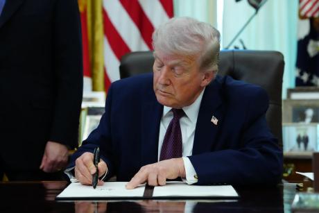 President Donald Trump signs an executive order on election integrity in the Oval Office of the White House in Washington on March 31, 2026.