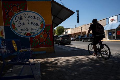 A cyclist rides their bike through downtown Del Rio on Aug. 21, 2024.