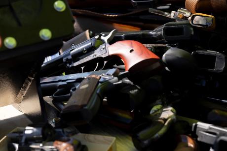 San Antonio police officers collect firearms and ammunition during a gun buyback event at the Alamodome on Nov. 24, 2024. 