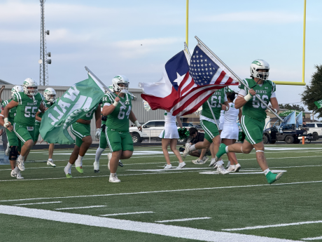 The Wall Hawks run onto the field before their game against Midland Greenwood on Friday, Sept. 25, 2026.