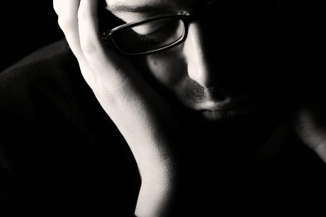 A depressed man with his head in hands (photo courtesy of wellingtonretreat.com)