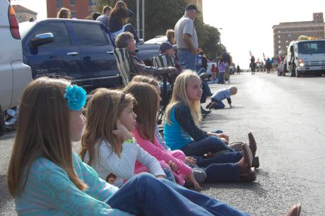 Children wait in anticipation as the next float approaches in the rodeo parade. (LIVE! Photo by Chelsea Schmid)