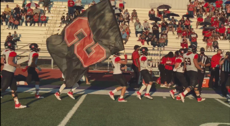 The Sonora Broncos charge onto the field before a game in 2020.