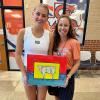 Pictured: Korbin Jastrow with her winning piece with Central High School art teacher Heather Shoop-York. 