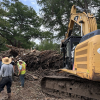 Workers sift through debris from the Guadalupe River flooding.