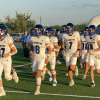 The Richland Springs Coyotes run onto the field before their football game against the Gordon Longhorns on Thursday, Aug. 28, 2025, in Priddy.