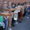 Female contestants see how long each can hold a beer stein at the 2023 Plateauberfest at Plateau Brewery Co.