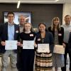 ASU Team (with certificates, L-R) Andres Ybarra, Katelyn St. John, Tatiana Alvarez and Ava James; Dr. Jeremy St. John (back row middle) and the contest judges. 