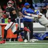 LA Rams' Matt Stafford dives at Atlanta's Xavier Watts after throwing an interception.