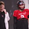 Texas Tech players Brendan Sorbsy (right) and Willi Hammond (back) and assistant quarterbacks coach Lindsey Scott look on during spring football practice at the at the Womble Football Center in Lubbock on April 7, 2026.