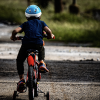 A child is shown riding a bicycle.