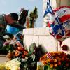U.S. Army Specialist Robert Orcutt prays near a makeshift memorial for victims of the shootings at Fort Hood Army post in Fort Hood on Nov. 9, 2009.