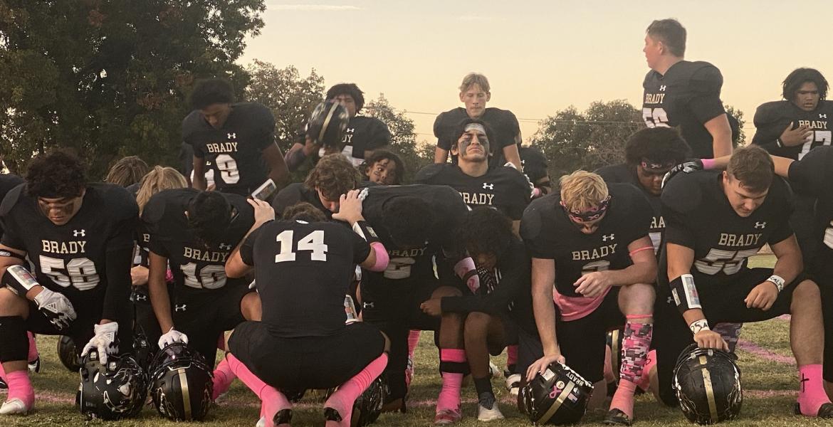 The Brady Bulldogs Pray Before Taking the Field Against the Ballinger Bearcats