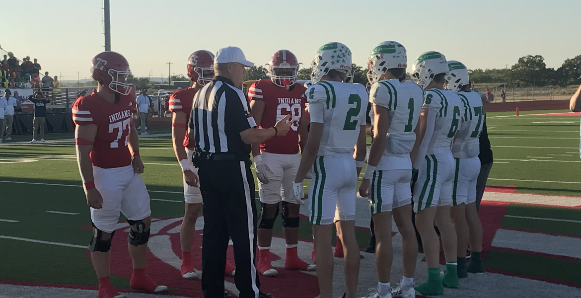 Captains for the Wall Hawks and Jim Ned Indians meet at midfield for the coin toss before their football game Friday, Sept. 12, 2025.
